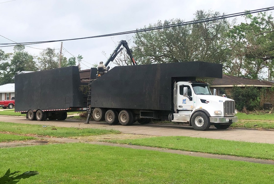 Truck picking up hurricane debris