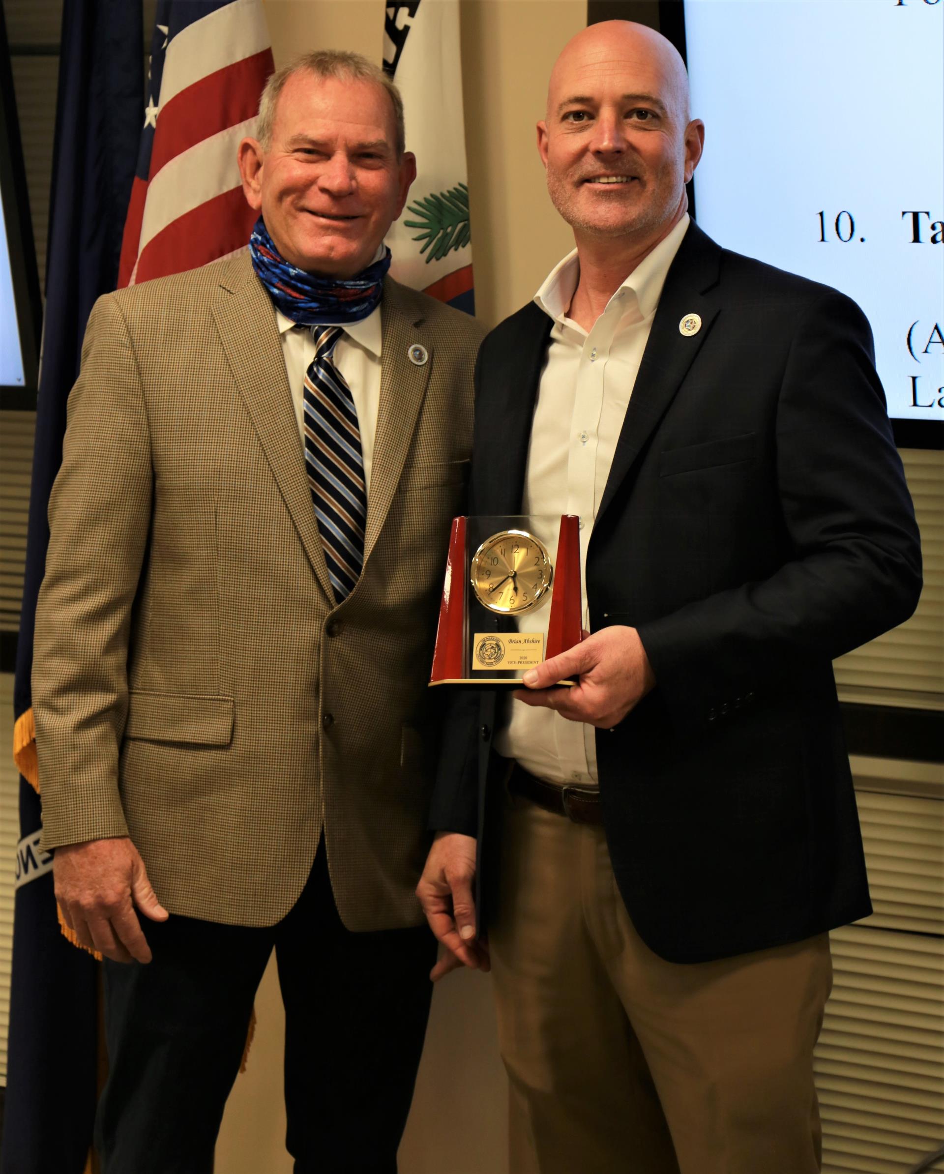 Incoming Police Jury Vice President Guy Brame (left) presents a plaque to outgoing VP Brian Abshire (right).