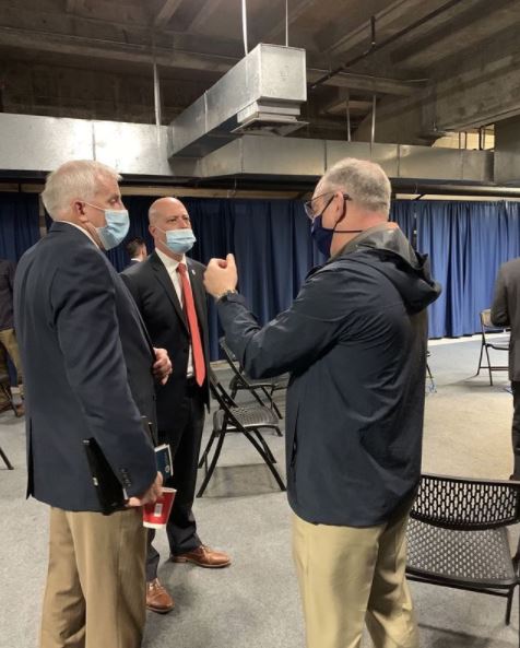 Gov. John Bel Edwards speaks with Police Jury President Brian Abshire (right - in back) and Dane Bolin, Assistant Parish Administrator (left in front), before Jan. 26 Tuesday’s Calcasieu Parish Long-Term Hurricane Recovery Framework press conference at the Burton Coliseum.