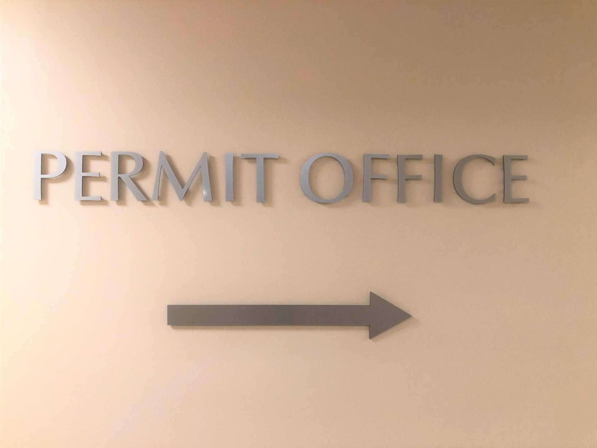 Sign on wall in Planning directing towards Permit Office