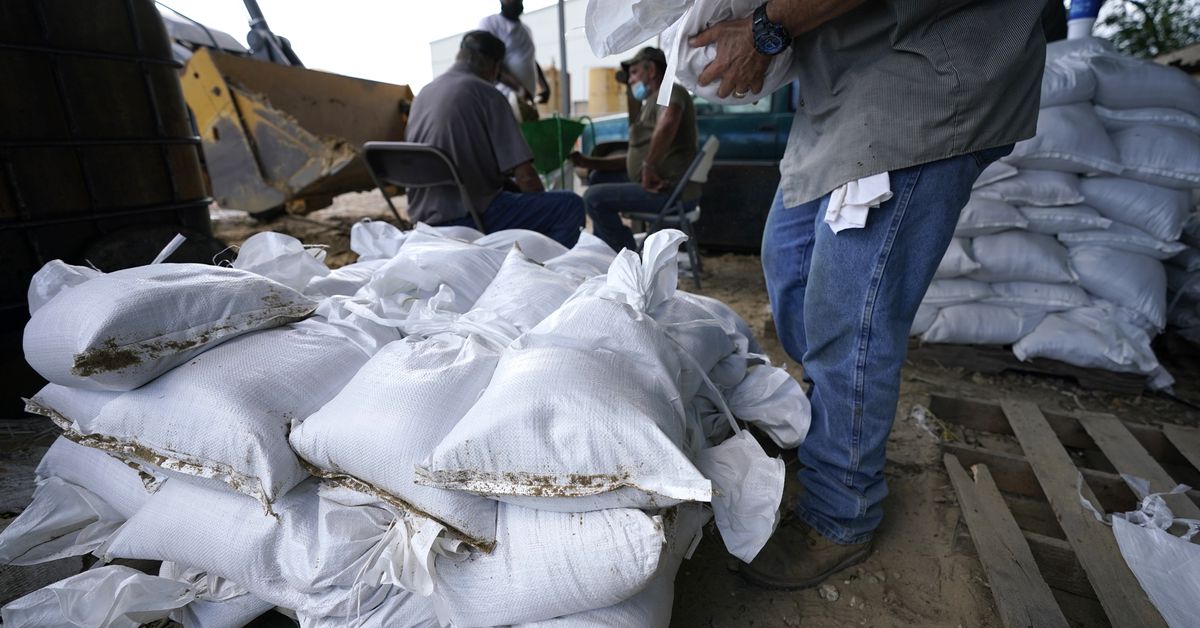 man filling sandbags at Burton Coliseum pre-storm