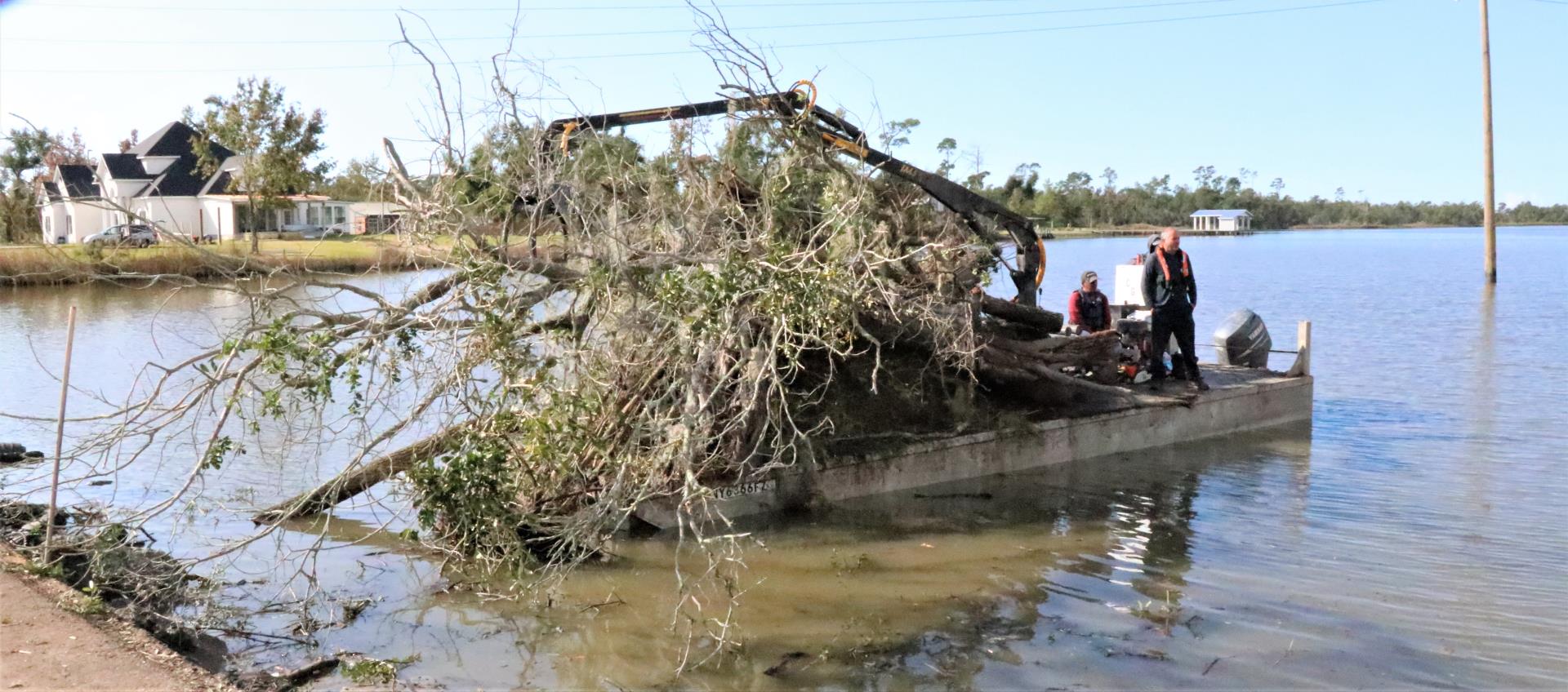 Barge removing hurricane debris from Calcasieu Parish drainage laterals with the contractor Crowder Gulf